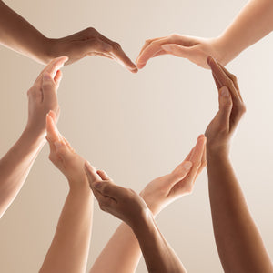 Photo. Symbol and shape of heart created from hands of different skin tones. The concept of unity, cooperation, partnership, teamwork and charity.